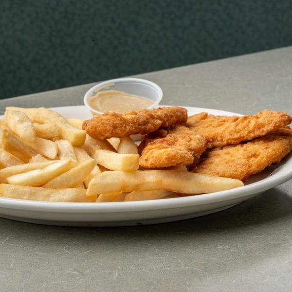 A plate of crispy chicken tenders and golden french fries with a side of dipping sauce.